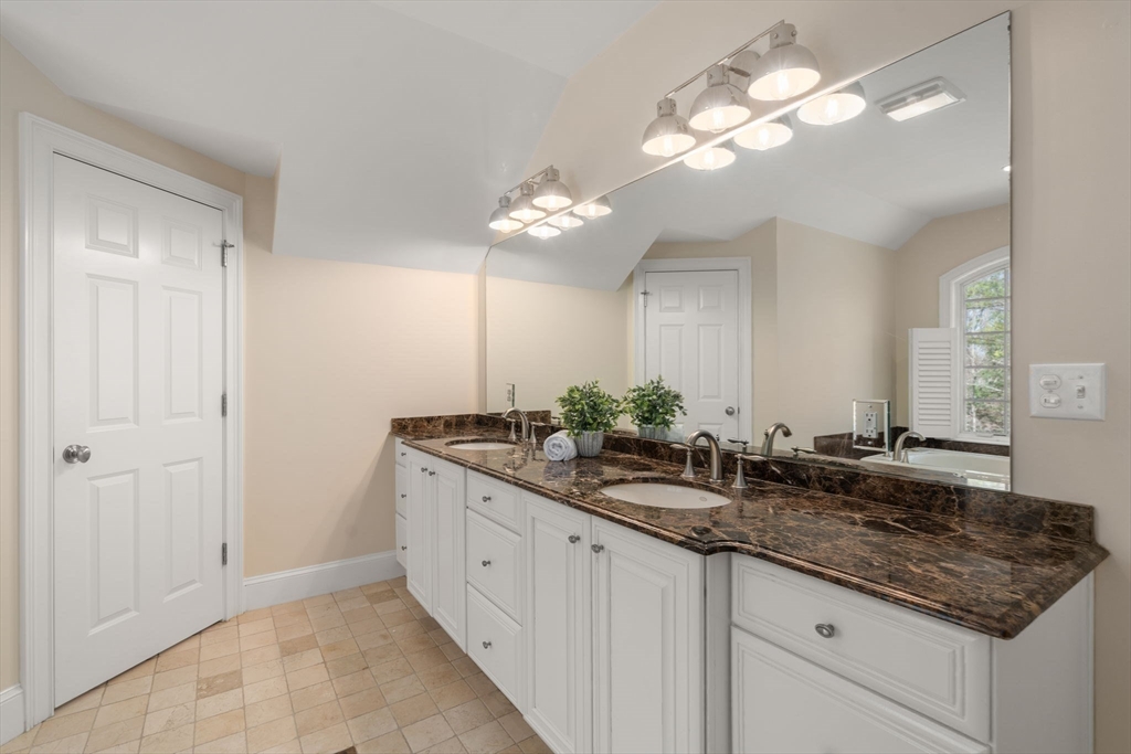 21 Westerly Road Weston, MA 02493 - Photo 19 of 38 a bathroom with a granite countertop double vanity sink and a mirror