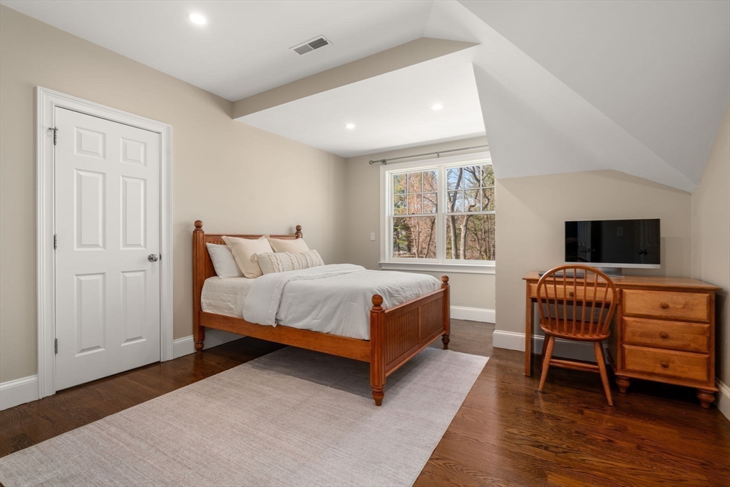 21 Westerly Road Weston, MA 02493 - Photo 22 of 38 a bedroom with a bed and wooden floor