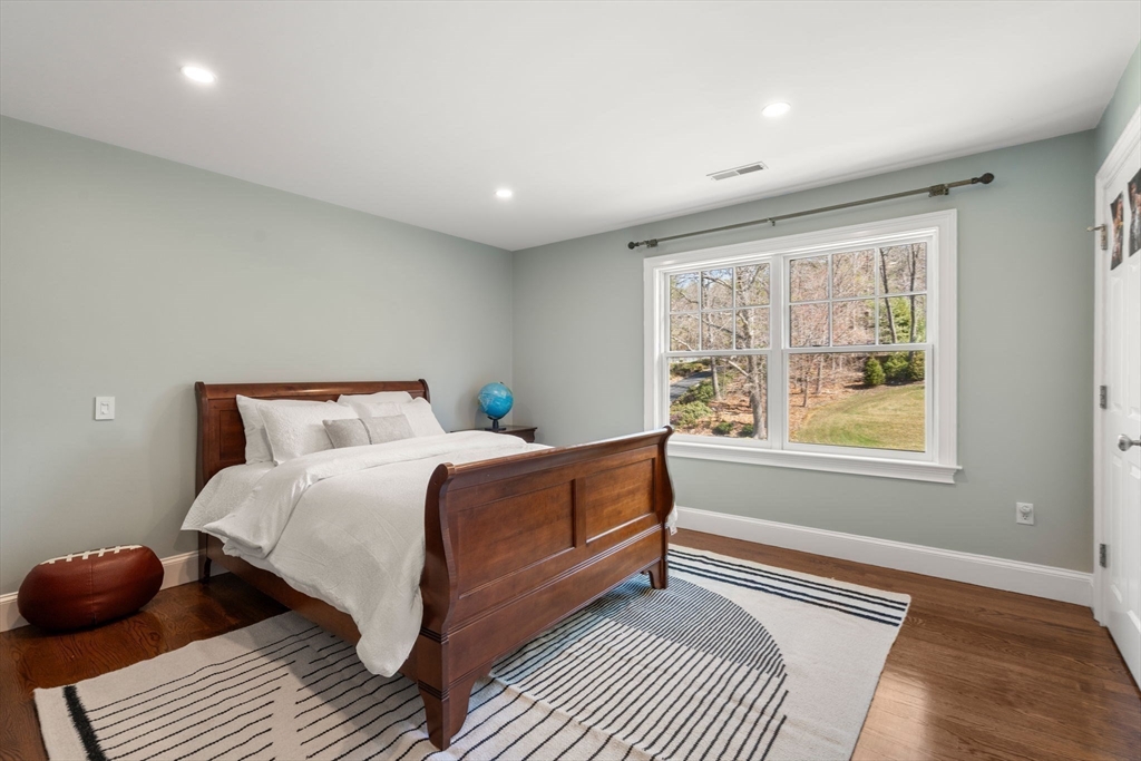 21 Westerly Road Weston, MA 02493 - Photo 23 of 38 a bedroom with a bed and wooden floor