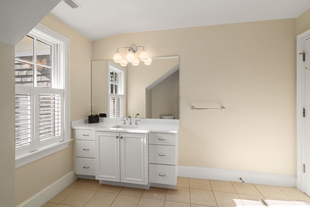 21 Westerly Road Weston, MA 02493 - Photo 24 of 38 a spacious bathroom with a double vanity sink a mirror and a bathtub
