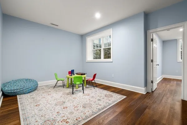 a view of a room with wooden floor and furniture