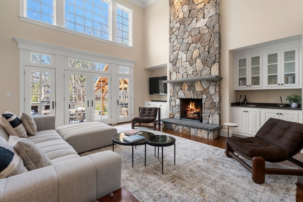 21 Westerly Road Weston, MA 02493 - Photo 3 of 38 a living room with furniture a fireplace and a large window