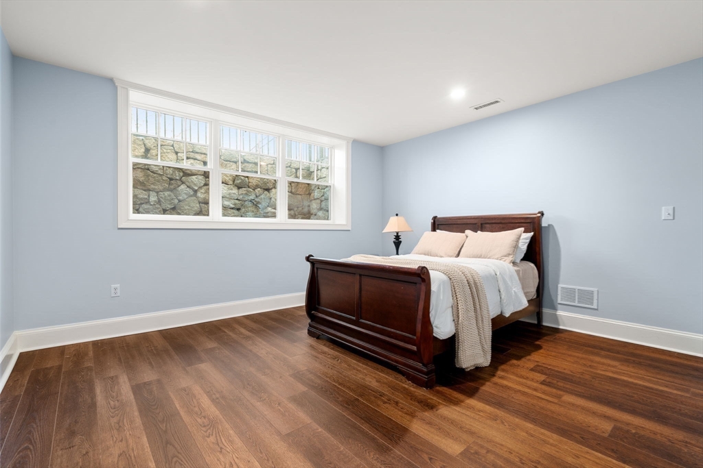 21 Westerly Road Weston, MA 02493 - Photo 31 of 38 a bedroom with a bed and wooden floor
