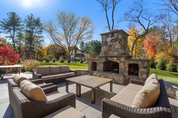 a outdoor living space with furniture and a fireplace