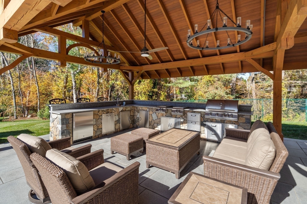 21 Westerly Road Weston, MA 02493 - Photo 34 of 38 a view of a patio with couches and a table and chairs with wooden floor