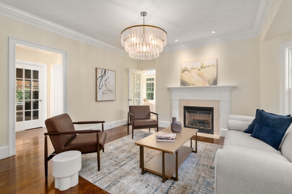 21 Westerly Road Weston, MA 02493 - Photo 9 of 38 a living room with furniture a chandelier and a fireplace