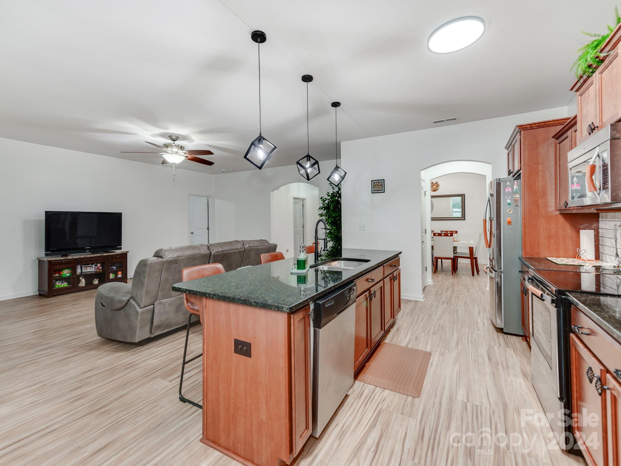 8080 Bryson Road Indian Land, SC 29707 - Photo 11 of 38 a kitchen with stainless steel appliances granite countertop a stove and a wooden floors