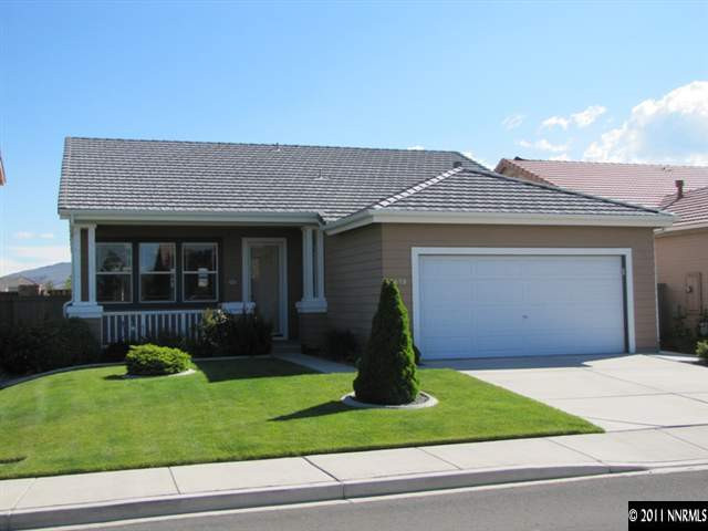 1670 Cattlemen Court Reno, NV 89521 - Photo 1 of 12 a front view of a house with a yard and garage