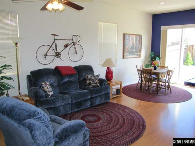 1670 Cattlemen Court Reno, NV 89521 - Photo 3 of 12 a living room with furniture a chandelier and a fireplace