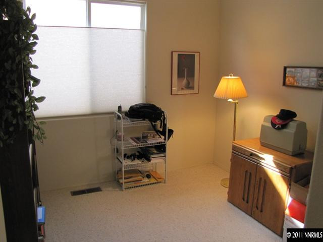 1670 Cattlemen Court Reno, NV 89521 - Photo 6 of 12 a bedroom with a bed and a lamp on the wall