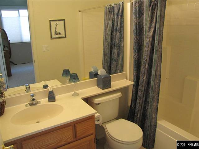 1670 Cattlemen Court Reno, NV 89521 - Photo 7 of 12 a bathroom with a sink a toilet and mirror