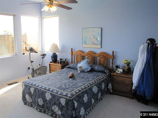1670 Cattlemen Court Reno, NV 89521 - Photo 8 of 12 a bedroom with a bed a window and dresser