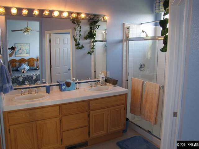 1670 Cattlemen Court Reno, NV 89521 - Photo 9 of 12 a bathroom with a double vanity sink and mirror