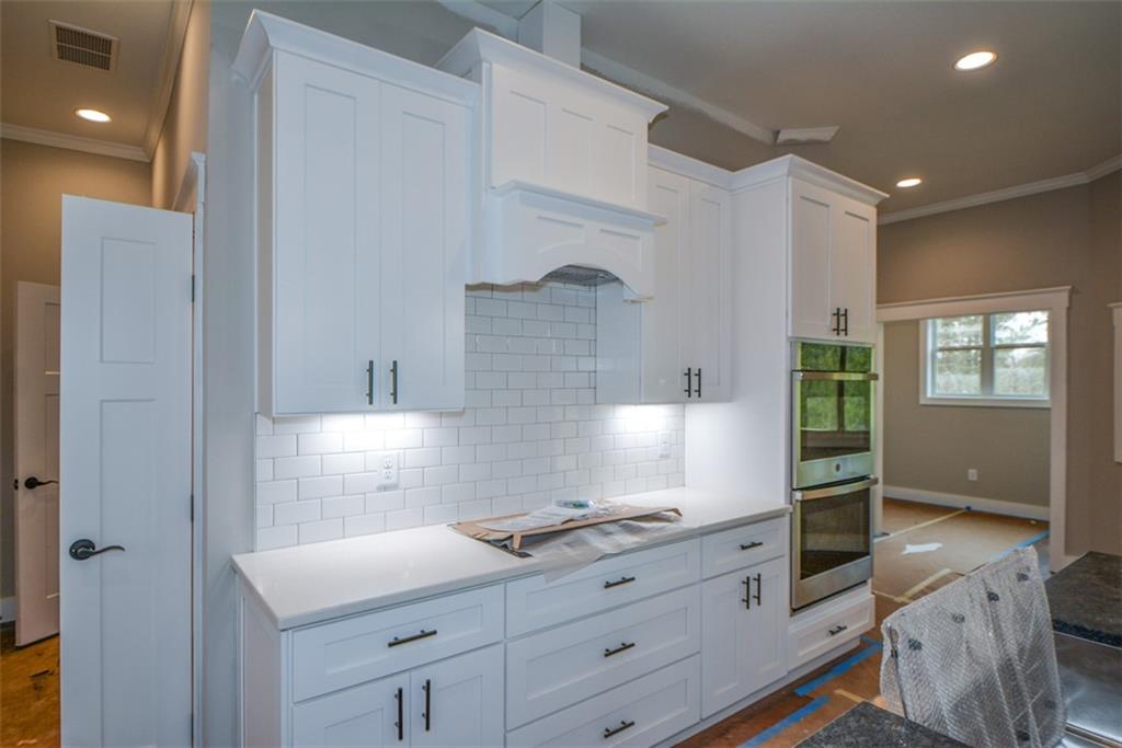 171 Field Stone Circle Jasper, GA 30143 - Photo 12 of 71 a kitchen with granite countertop white cabinets and white appliances
