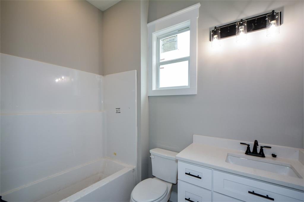 171 Field Stone Circle Jasper, GA 30143 - Photo 45 of 71 a bathroom with a toilet sink vanity tub and mirror