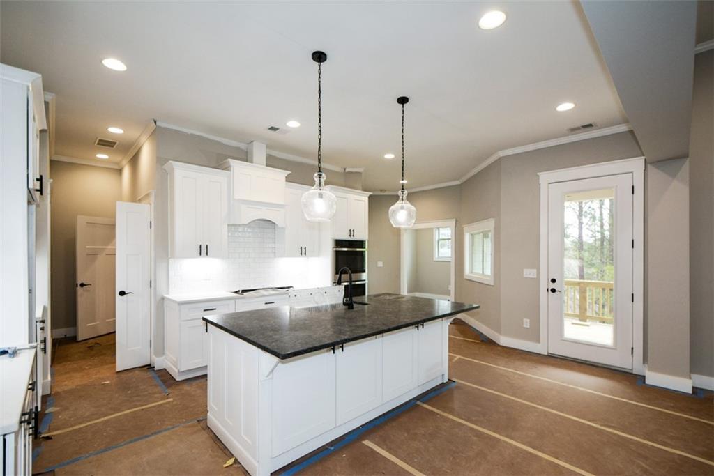 171 Field Stone Circle Jasper, GA 30143 - Photo 10 of 71 a kitchen with granite countertop a sink a counter and stainless steel appliances