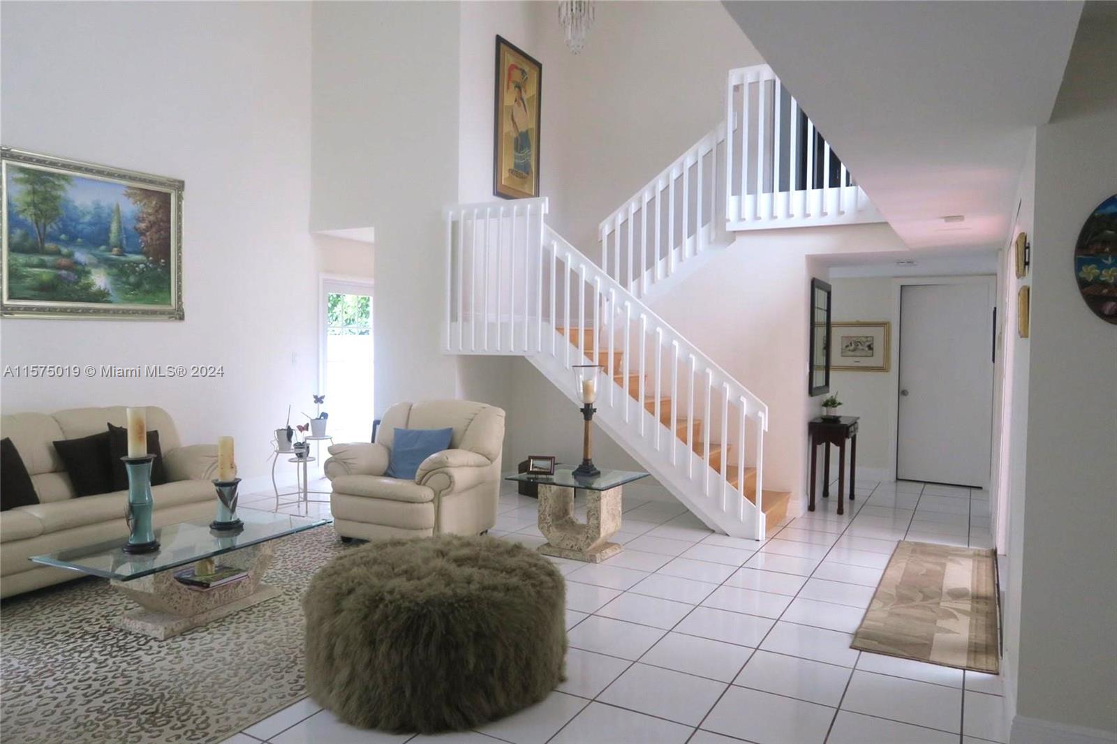 a living room with furniture and stairs