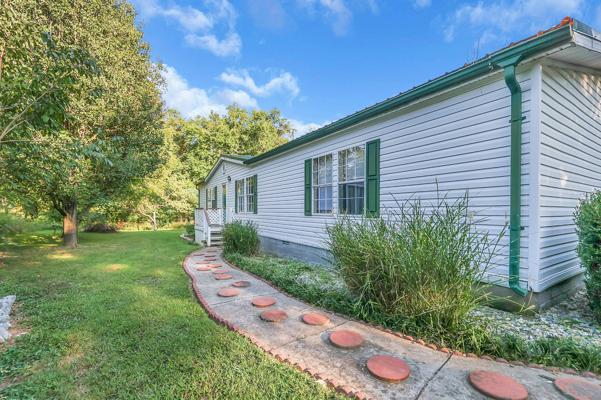 1241 Quarry Road Mount Juliet, TN 37122 - Photo 1 of 29 a view of a backyard with potted plants and large tree