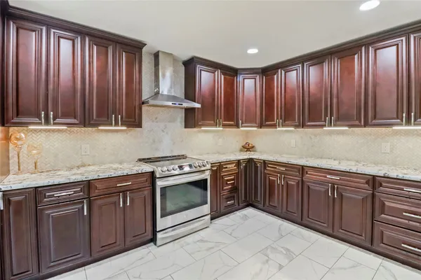 a kitchen with stainless steel appliances granite countertop wooden cabinets a sink and dishwasher