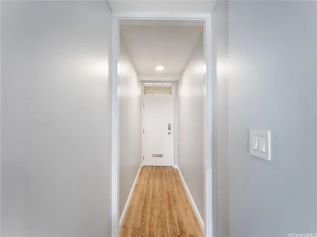 a view of a hallway with wooden floor