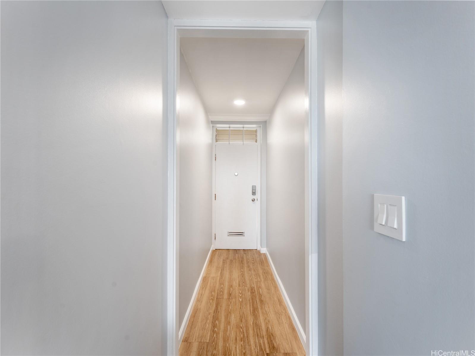 4300 Waialae Avenue, Unit B601 Honolulu, HI 96816 - Photo 11 of 18 a view of a hallway with wooden floor