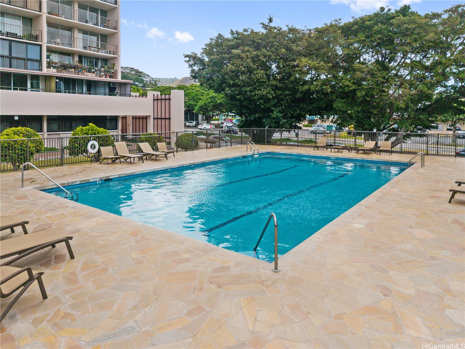 4300 Waialae Avenue, Unit B601 Honolulu, HI 96816 - Photo 17 of 18 a view of a swimming pool with an outdoor seating