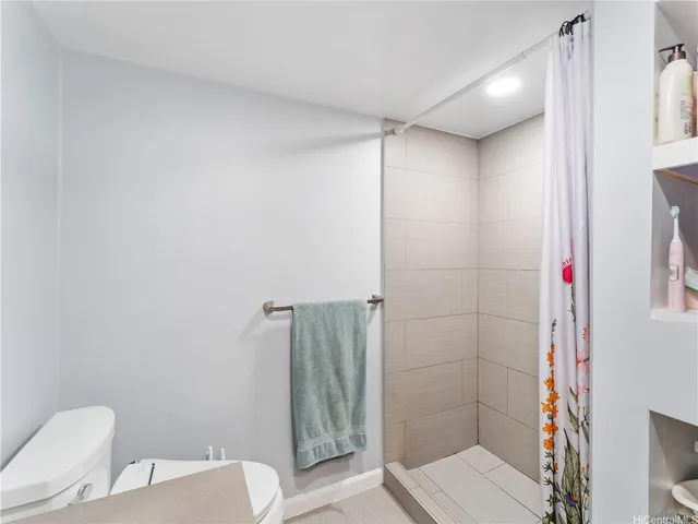 a bathroom with a shower and toilet
