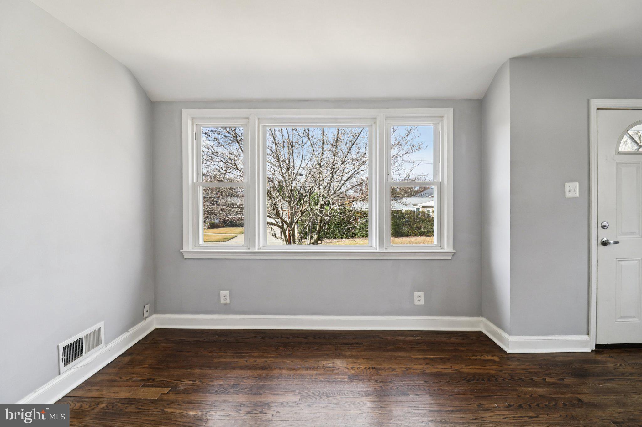 11515 Orebaugh Avenue Silver Spring, MD 20902 - Photo 11 of 69 a view of an empty room with wooden floor and a window