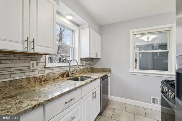 a kitchen with stainless steel appliances granite countertop a refrigerator stove and microwave