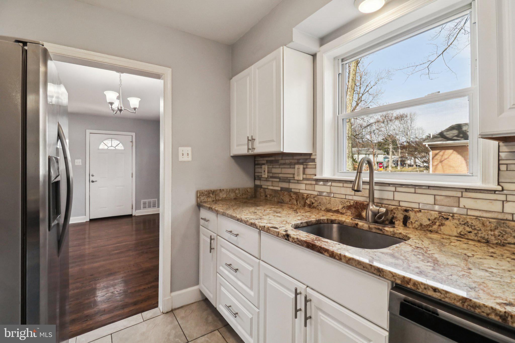 11515 Orebaugh Avenue Silver Spring, MD 20902 - Photo 14 of 69 a kitchen with granite countertop a sink and a window