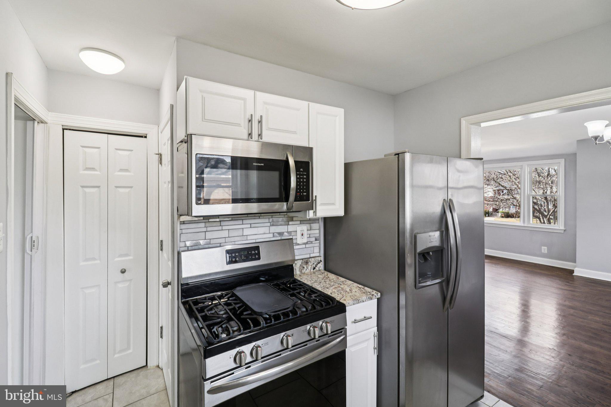 11515 Orebaugh Avenue Silver Spring, MD 20902 - Photo 15 of 69 a kitchen with stainless steel appliances granite countertop a refrigerator stove and microwave