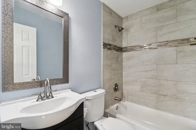 a bathroom with a sink a toilet and a bathtub