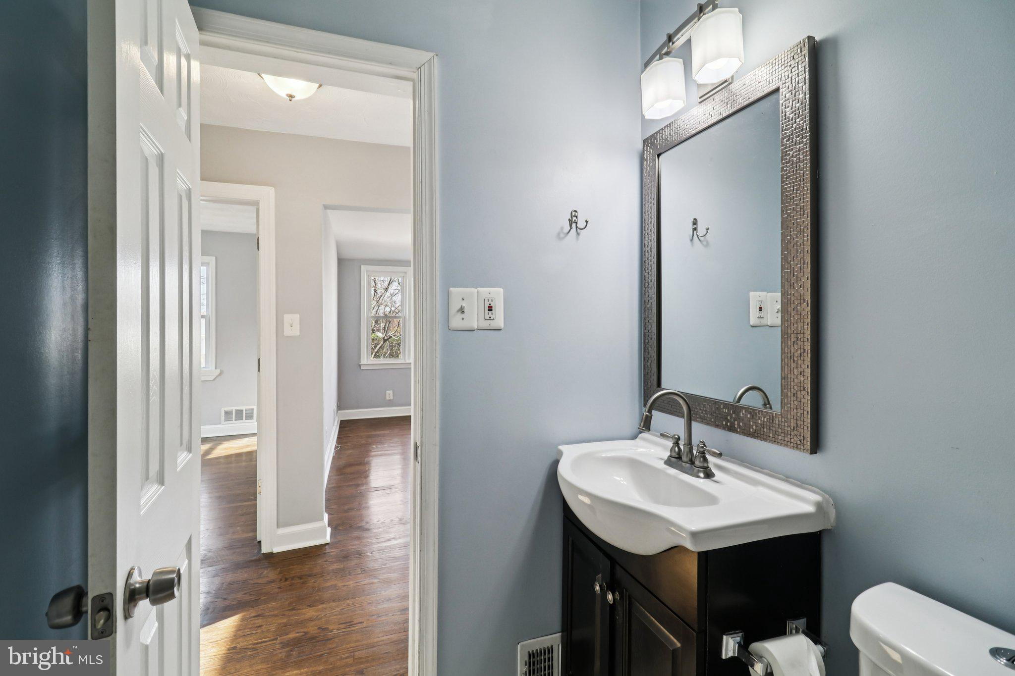 11515 Orebaugh Avenue Silver Spring, MD 20902 - Photo 20 of 69 a bathroom with a sink a light fixture and a mirror