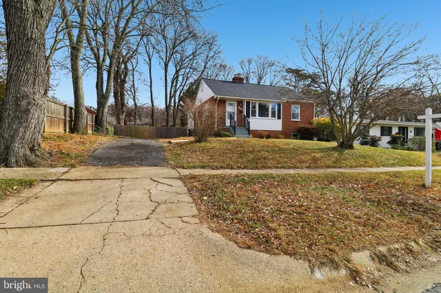 a view of a house with a yard covered with snow in the background