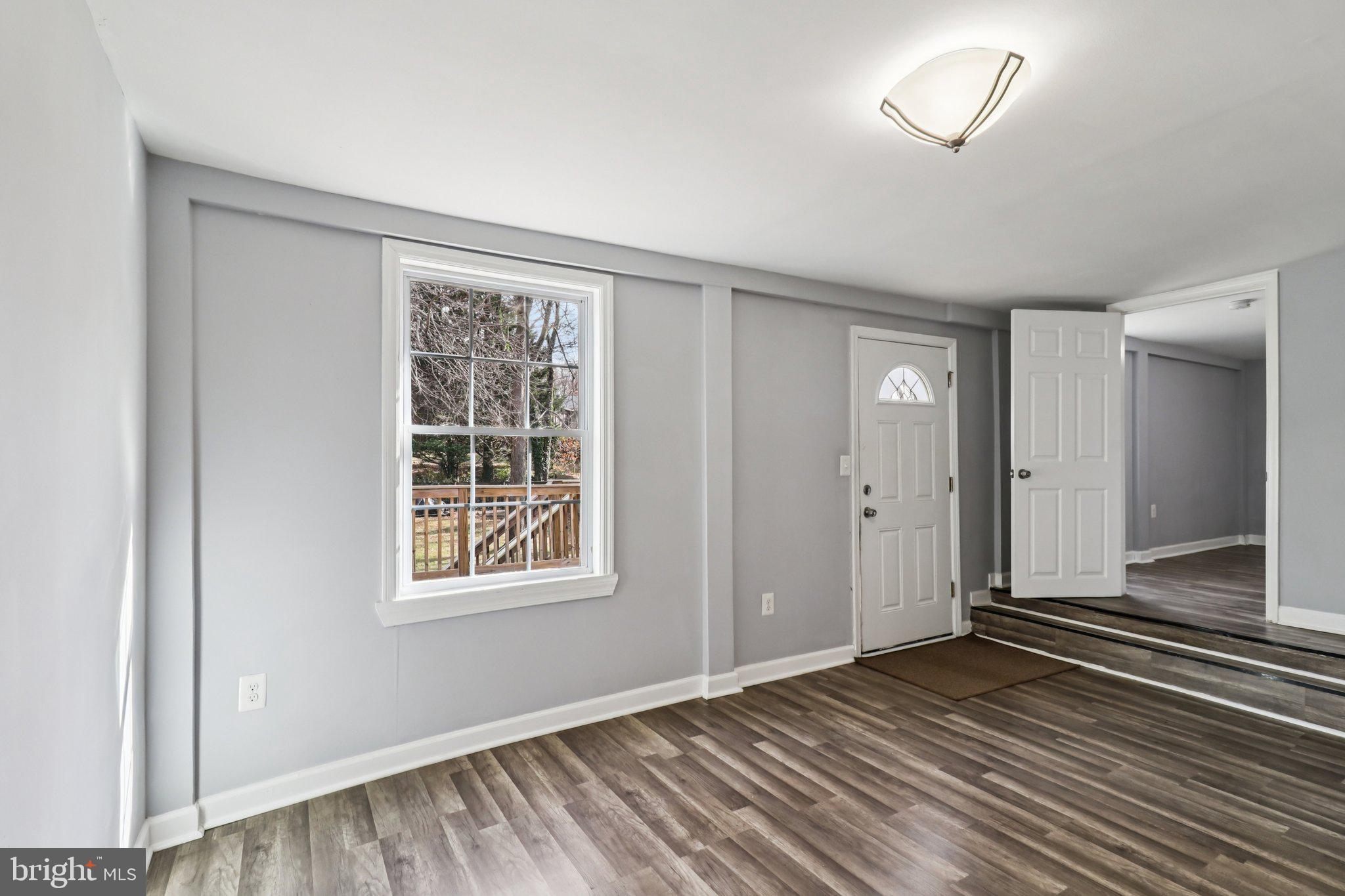 11515 Orebaugh Avenue Silver Spring, MD 20902 - Photo 27 of 69 a view of an empty room with wooden floor and a window