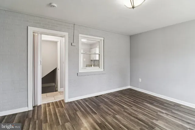 a view of a room with wooden floor and bathroom