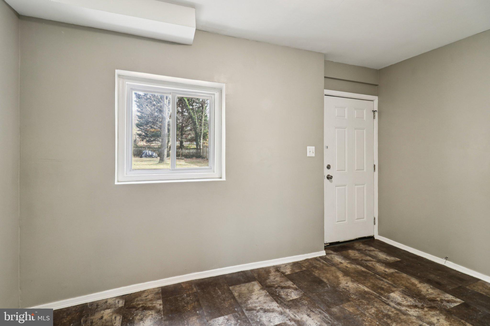 11515 Orebaugh Avenue Silver Spring, MD 20902 - Photo 48 of 69 a view of an empty room with wooden floor and a window