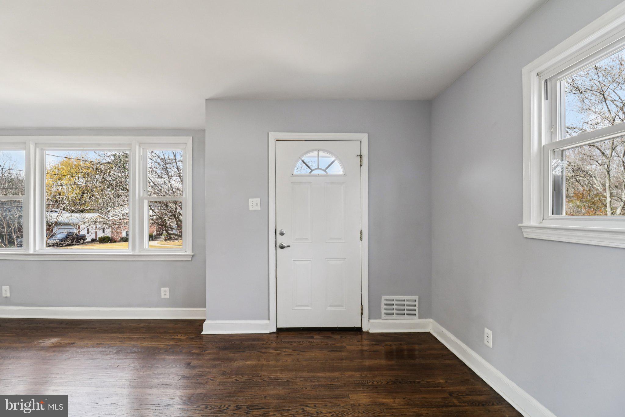 11515 Orebaugh Avenue Silver Spring, MD 20902 - Photo 6 of 69 a view of an empty room with wooden floor and a window