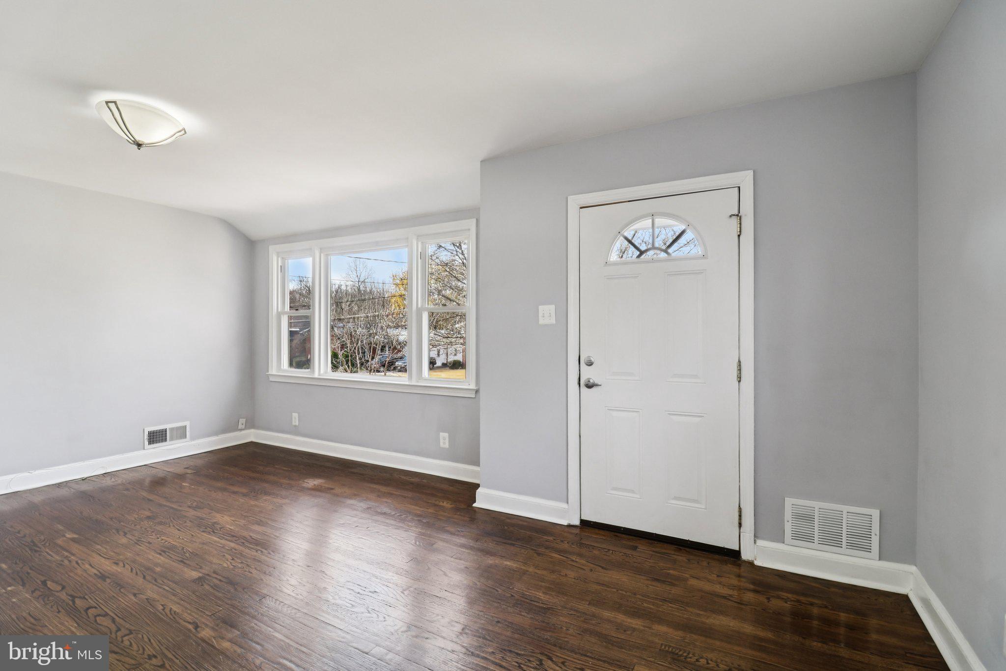 11515 Orebaugh Avenue Silver Spring, MD 20902 - Photo 7 of 69 an empty room with wooden floor and windows