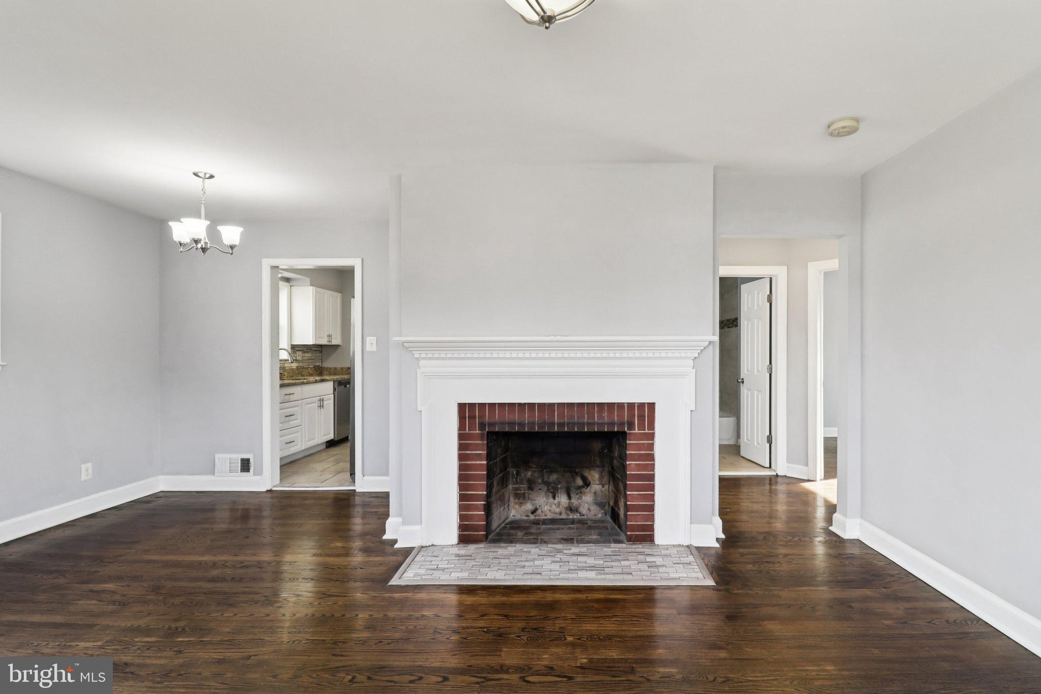 11515 Orebaugh Avenue Silver Spring, MD 20902 - Photo 9 of 69 a view of an empty room with wooden floor and fireplace