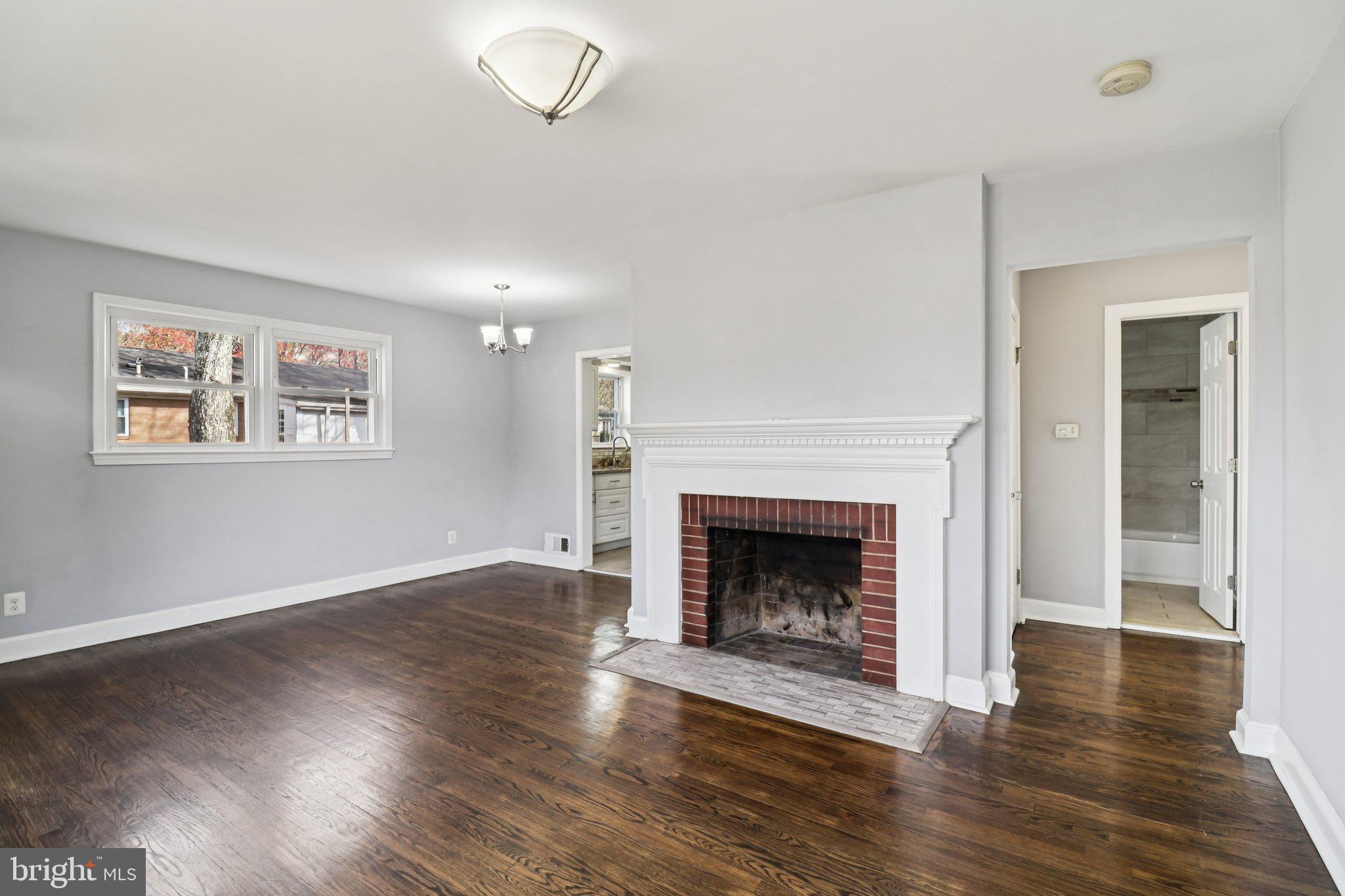 11515 Orebaugh Avenue Silver Spring, MD 20902 - Photo 10 of 69 a living room with wooden floor and a fireplace