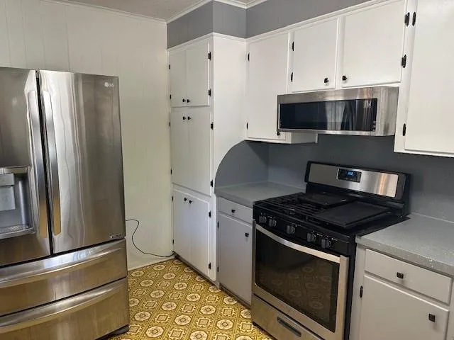 a kitchen with stainless steel appliances granite countertop a stove and a refrigerator