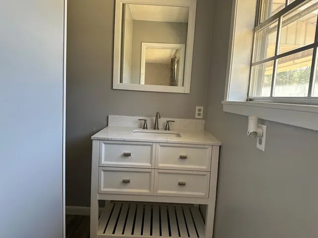 a bathroom with a sink and a mirror