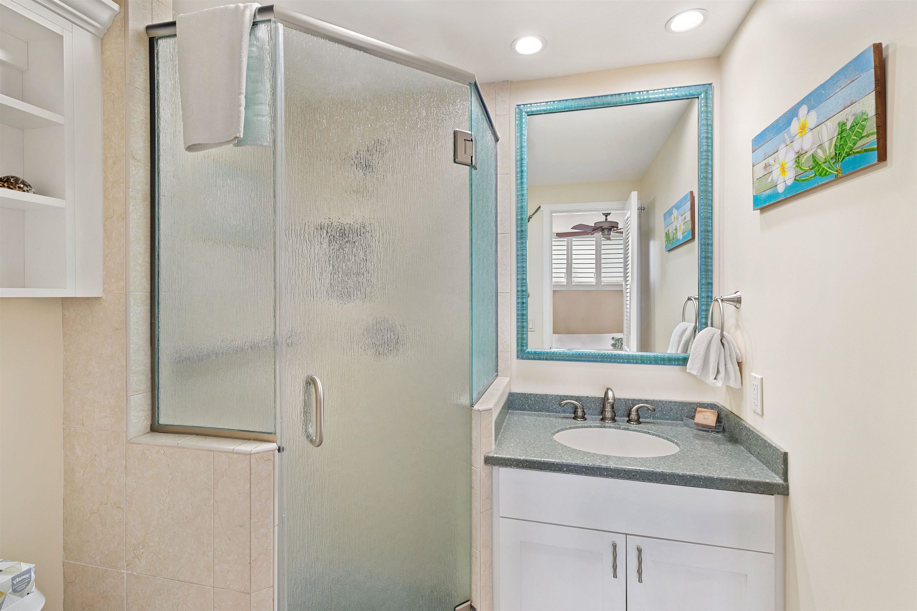 2480 South Kihei Road, Unit 702 Kihei, HI 96753 - Photo 14 of 24 a bathroom with a granite countertop sink a mirror a vanity and shower