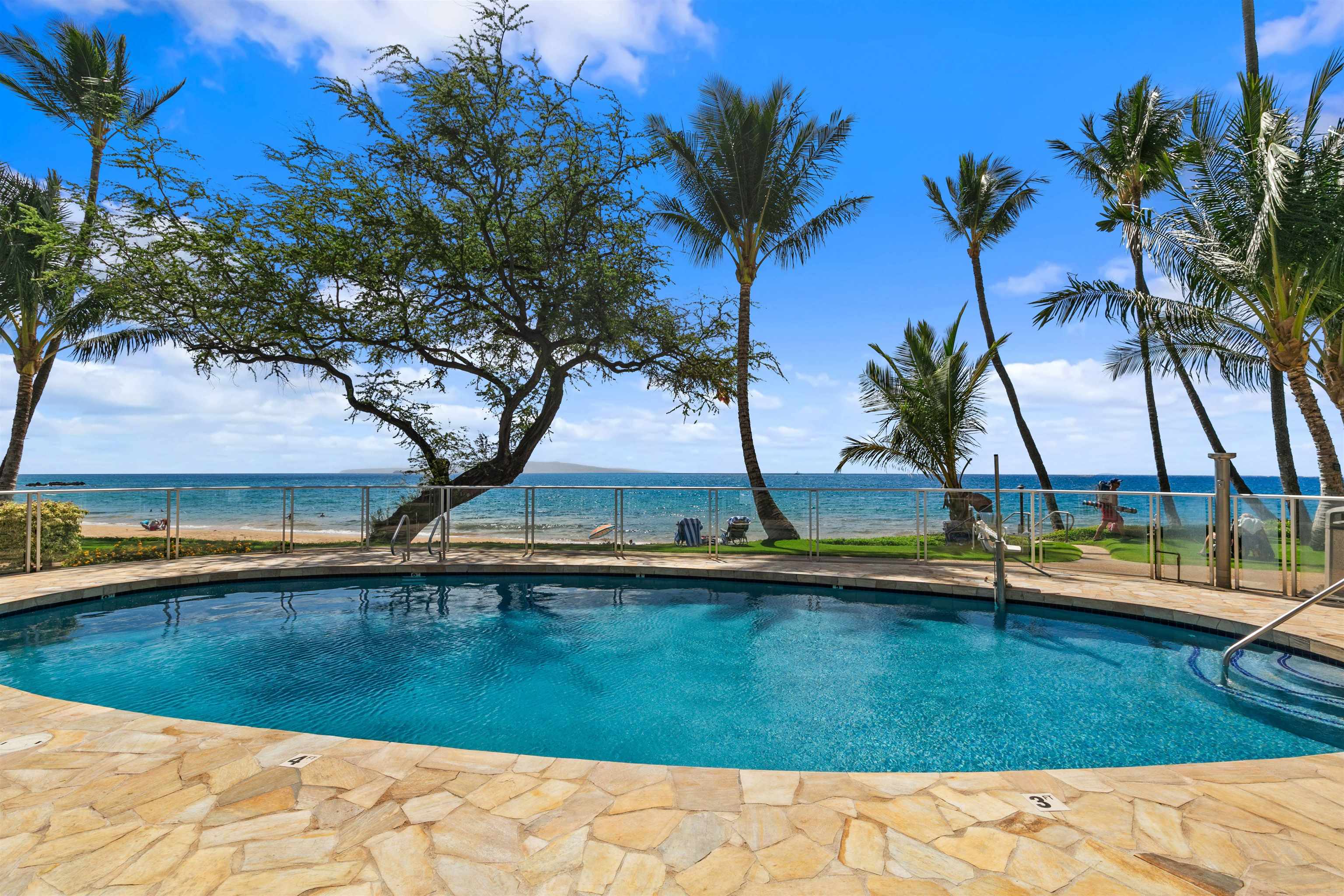 2480 South Kihei Road, Unit 702 Kihei, HI 96753 - Photo 20 of 24 a view of swimming pool with a table and chairs