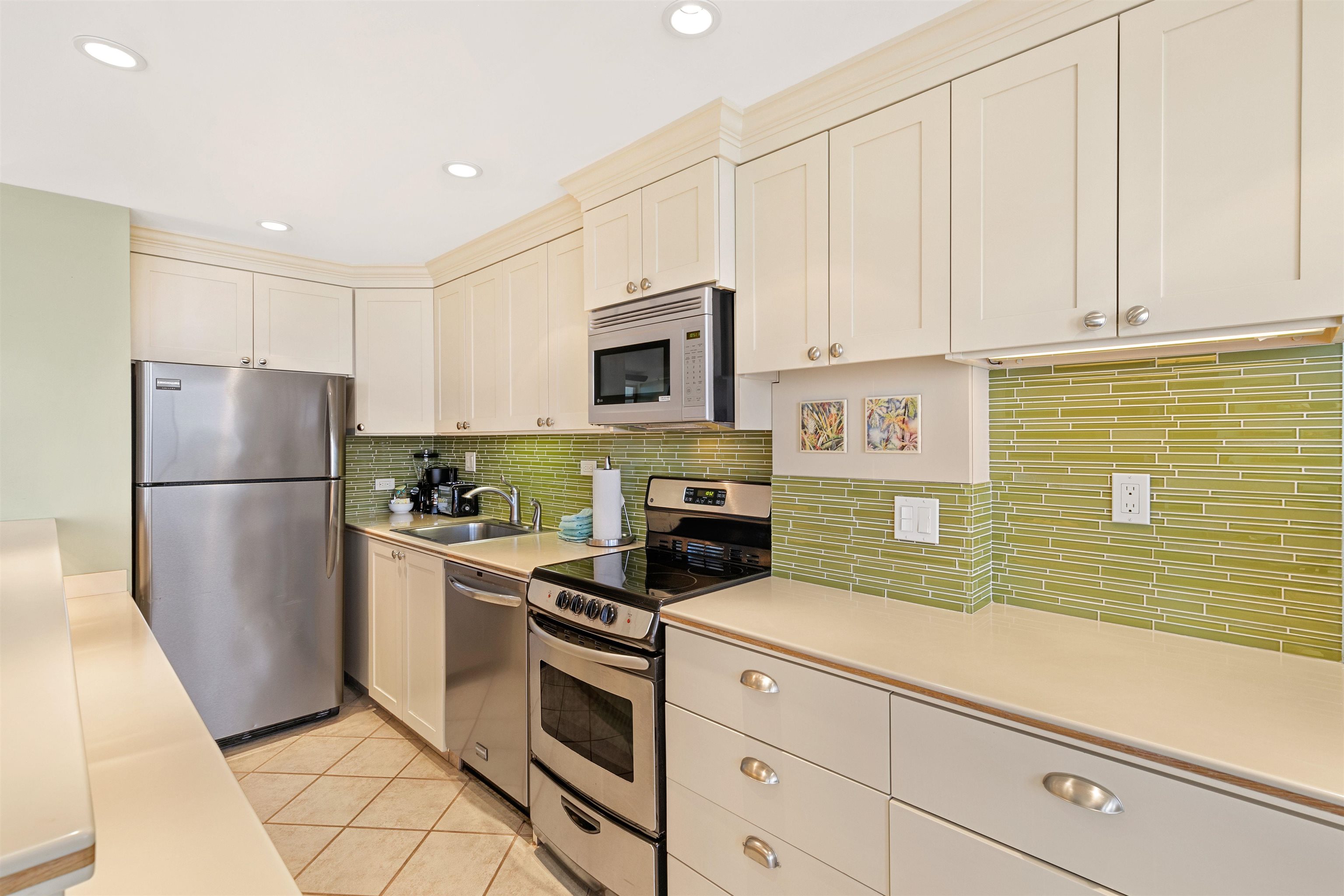 2480 South Kihei Road, Unit 702 Kihei, HI 96753 - Photo 10 of 24 a kitchen with a refrigerator sink and cabinets