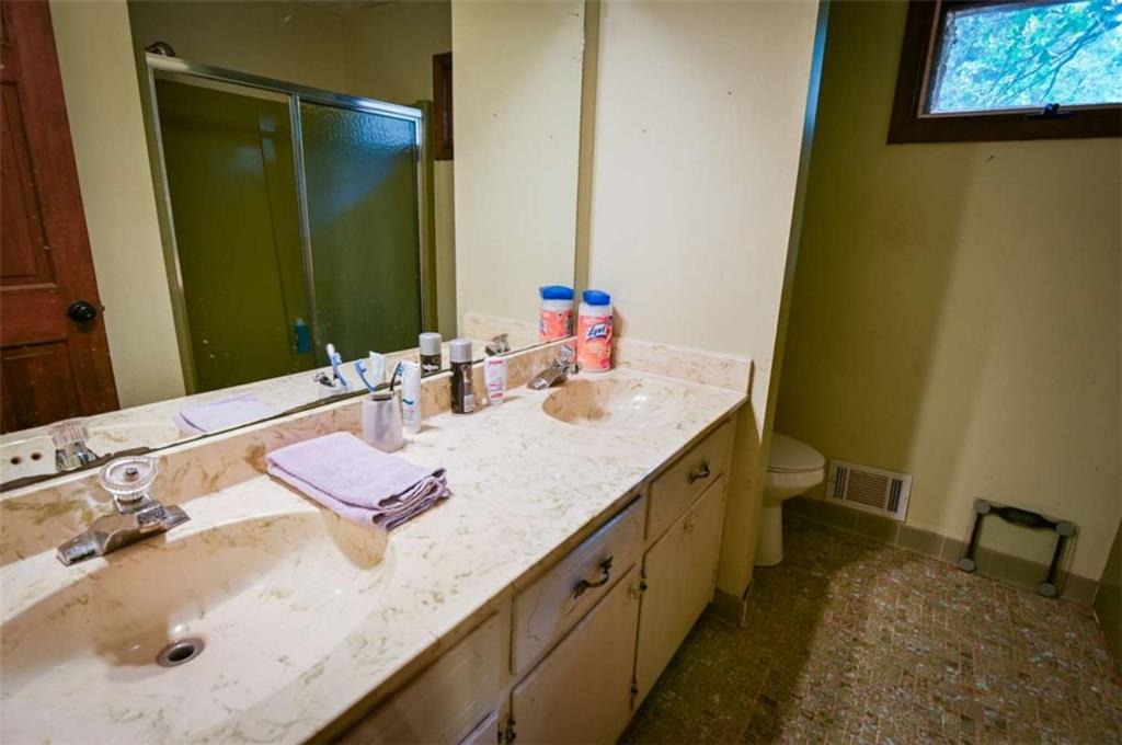 17 Valley Trail Covington, GA 30014 - Photo 11 of 19 a bathroom with a granite countertop sink and a mirror