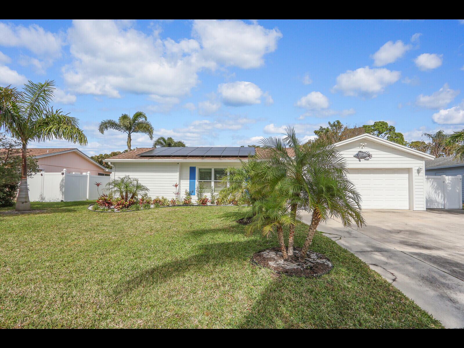 609 Oak Terrace Jupiter, FL 33458 - Photo 2 of 28 a front view of a house with a garden