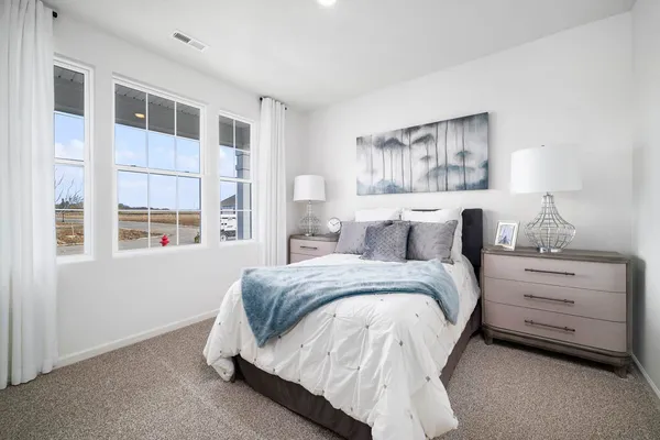 a spacious bedroom with a bed and a window