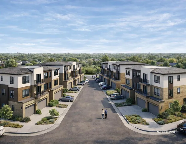 an aerial view of residential houses with outdoor space